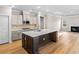 Open concept kitchen boasts an island with a sink and stainless appliances at 5032 Cambria Ct., Little River, SC 29566