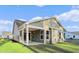 A covered patio sits on the rear of this home in a grassy yard at 5032 Cambria Ct., Little River, SC 29566