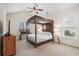 Bedroom features a four poster bed, carpet floors, and ample natural light at 621 Elgin Ct., Myrtle Beach, SC 29579