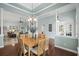 Elegant dining room with hardwood floors, decorative columns, and a chandelier is perfect for entertaining at 621 Elgin Ct., Myrtle Beach, SC 29579