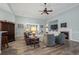 Cozy living room with a fireplace, plush seating, and a ceiling fan at 621 Elgin Ct., Myrtle Beach, SC 29579