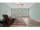 Bright living room features hardwood floors, a ceiling fan, area rug, and many windows for natural light at 621 Elgin Ct., Myrtle Beach, SC 29579
