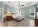 Serene main bedroom boasts tray ceilings, a ceiling fan, and plenty of natural light at 621 Elgin Ct., Myrtle Beach, SC 29579