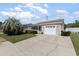 Beige house with white garage door and landscaping at 9557 Sullivan Dr., Murrells Inlet, SC 29576