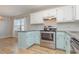 Modern kitchen with stainless steel appliances and light teal cabinets at 9557 Sullivan Dr., Murrells Inlet, SC 29576