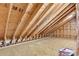 Unfinished attic space featuring exposed wooden beams and plywood flooring at 1002 Summers Pl., North Myrtle Beach, SC 29582