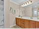 Bathroom featuring a double vanity with wooden cabinets and decorative artwork on the walls at 1002 Summers Pl., North Myrtle Beach, SC 29582
