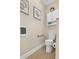 This half bath features neutral walls, tiled floors and white fixtures at 1002 Summers Pl., North Myrtle Beach, SC 29582