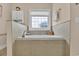 A soaking tub is surrounded by tile and features a window at 1002 Summers Pl., North Myrtle Beach, SC 29582