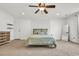 Bright bedroom with a ceiling fan, carpeted floor, a door, and decorative wall panels at 1002 Summers Pl., North Myrtle Beach, SC 29582