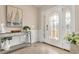 Entryway featuring decorative glass door, tiled floors, and a mirrored console table with decor at 1002 Summers Pl., North Myrtle Beach, SC 29582