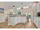 Open kitchen with breakfast bar, granite countertops, modern cabinets and a pass-through window at 1002 Summers Pl., North Myrtle Beach, SC 29582