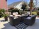 Outdoor patio with wicker furniture surrounding a gas fire pit at 1002 Summers Pl., North Myrtle Beach, SC 29582