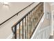 Stairway with carpeted steps, decorative metal railings, and white decorative molding at 1002 Summers Pl., North Myrtle Beach, SC 29582