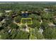 Aerial view of a property surrounded by trees, with a yellow line showing property lines at 1562 Hawthorn Dr., Pawleys Island, SC 29585