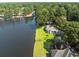 An aerial view of a waterfront property surrounded by lush trees and overlooking the water at 1562 Hawthorn Dr., Pawleys Island, SC 29585