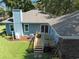 An aerial view of a home's backyard featuring a wooden deck with outdoor seating at 1562 Hawthorn Dr., Pawleys Island, SC 29585