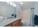 Cozy bathroom with granite counters, single vanity, toilet, and shower-tub combo at 1562 Hawthorn Dr., Pawleys Island, SC 29585