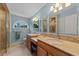 Bathroom featuring dual vanities, warm lighting, and a separate glass shower at 1562 Hawthorn Dr., Pawleys Island, SC 29585