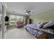 Bedroom featuring a lake view, comfortable seating, and a decorative ceiling fan at 1562 Hawthorn Dr., Pawleys Island, SC 29585