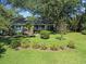 A charming home with brick facade, landscaped garden and a welcoming front porch at 1562 Hawthorn Dr., Pawleys Island, SC 29585