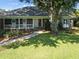 The house has a brick facade, white columns, and a manicured lawn at 1562 Hawthorn Dr., Pawleys Island, SC 29585