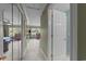 Hallway showcasing neutral tones, closet, and views of the living area and lake at 1562 Hawthorn Dr., Pawleys Island, SC 29585