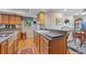 Kitchen features a breakfast bar, wood cabinets, and granite countertops at 1562 Hawthorn Dr., Pawleys Island, SC 29585