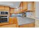 Kitchen featuring stainless steel appliances, wood cabinetry, and granite countertops at 1562 Hawthorn Dr., Pawleys Island, SC 29585