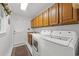 Functional laundry room with white appliances and ample storage cabinets at 1562 Hawthorn Dr., Pawleys Island, SC 29585