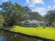 A view of the back of the house with a sunroom, deck, and waterfront access at 1562 Hawthorn Dr., Pawleys Island, SC 29585