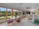 Cozy sunroom boasts scenic lake views, comfortable seating, and lots of natural light at 1562 Hawthorn Dr., Pawleys Island, SC 29585