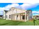 Back exterior featuring a covered patio, sliding glass doors, a spacious backyard, and white siding at 5028 Cambria Ct., Little River, SC 29566