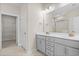 Bathroom showcasing a double vanity, neutral walls, a walk-in closet, and a separate shower area at 5028 Cambria Ct., Little River, SC 29566