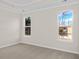 Bright bedroom featuring two large windows with views of the surrounding landscape and tray ceiling at 5028 Cambria Ct., Little River, SC 29566