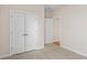 An empty bedroom featuring plush carpet flooring, neutral wall paint, and a closet at 5028 Cambria Ct., Little River, SC 29566