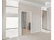 Open bedroom with neutral walls, carpet floors, and doors leading to the bathroom and walk-in closet at 5028 Cambria Ct., Little River, SC 29566