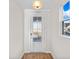 Bright entryway featuring a glass-paneled front door, hardwood floors, and trim at 5028 Cambria Ct., Little River, SC 29566