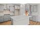 Well-lit kitchen featuring gray cabinets, stainless steel hood, and white countertops at 5028 Cambria Ct., Little River, SC 29566
