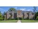 Large two-story home with a stone tower facade, beautiful landscaping, and a well-manicured lawn at 1126 Cherrystone Loop, Conway, SC 29526