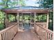 Wooden gazebo with railings overlooking a river, surrounded by lush greenery at 1126 Cherrystone Loop, Conway, SC 29526