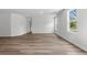 Bright living room featuring wood-look floors and white walls with natural light from the window at 1126 Cherrystone Loop, Conway, SC 29526