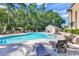 Outdoor pool with lounge chairs, umbrellas, and a pool house in a serene setting at 1126 Cherrystone Loop, Conway, SC 29526