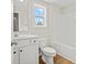 Bright bathroom features a white vanity, toilet, and tub with a window providing natural light at 2612 Old Charleston Rd., Georgetown, SC 29440