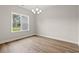 Bright dining area featuring wood floors, a window, and a modern chandelier at 2612 Old Charleston Rd., Georgetown, SC 29440