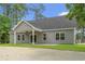 Charming gray home with a covered porch and a well-maintained lawn at 2612 Old Charleston Rd., Georgetown, SC 29440