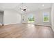 Open living area with wood flooring, sliding glass doors, and abundant natural light at 2612 Old Charleston Rd., Georgetown, SC 29440