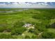 Breathtaking aerial view of an estate on a golf course surrounded by lush greenery and a river nearby at 89 Gleneagle Ln., Pawleys Island, SC 29585