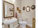 Charming powder room features a pedestal sink and decorative mirrors at 89 Gleneagle Ln., Pawleys Island, SC 29585