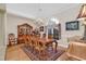 Elegant dining room featuring hardwood floors, a chandelier, and a decorative china cabinet, perfect for entertaining at 89 Gleneagle Ln., Pawleys Island, SC 29585